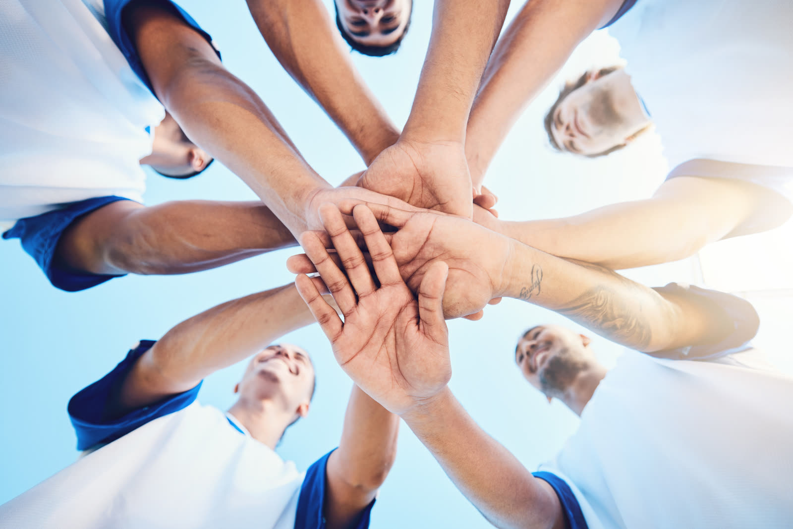 A football team in a huddle, hands together before the match